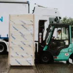 Forklift driver at Unilin Insulation on the way to load lorry for order distribution